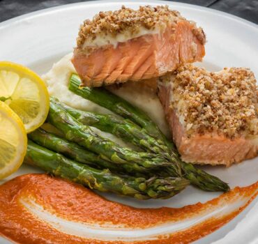 Pecan crusted salmon with roasted red pepper sauce by Crave Catering