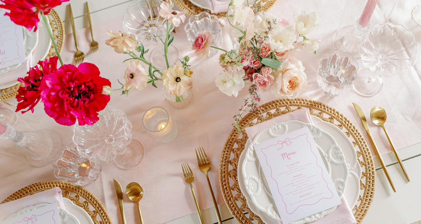 gold placesetting on light pink linen