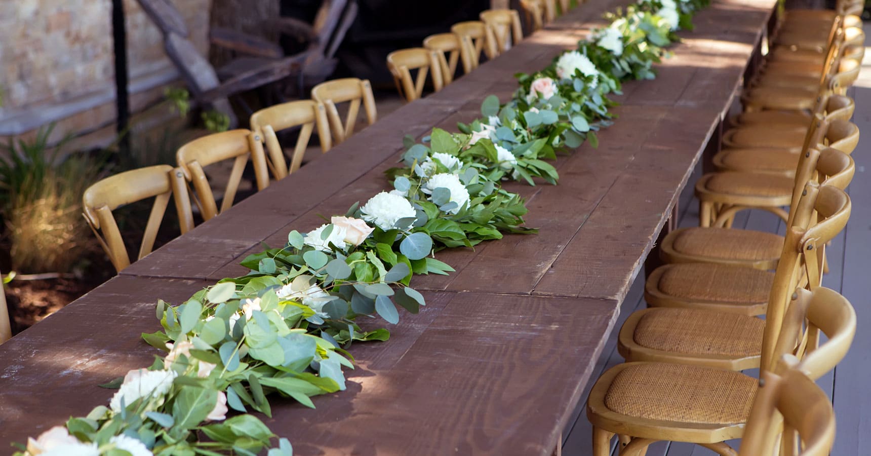 long wooden table with floral runner