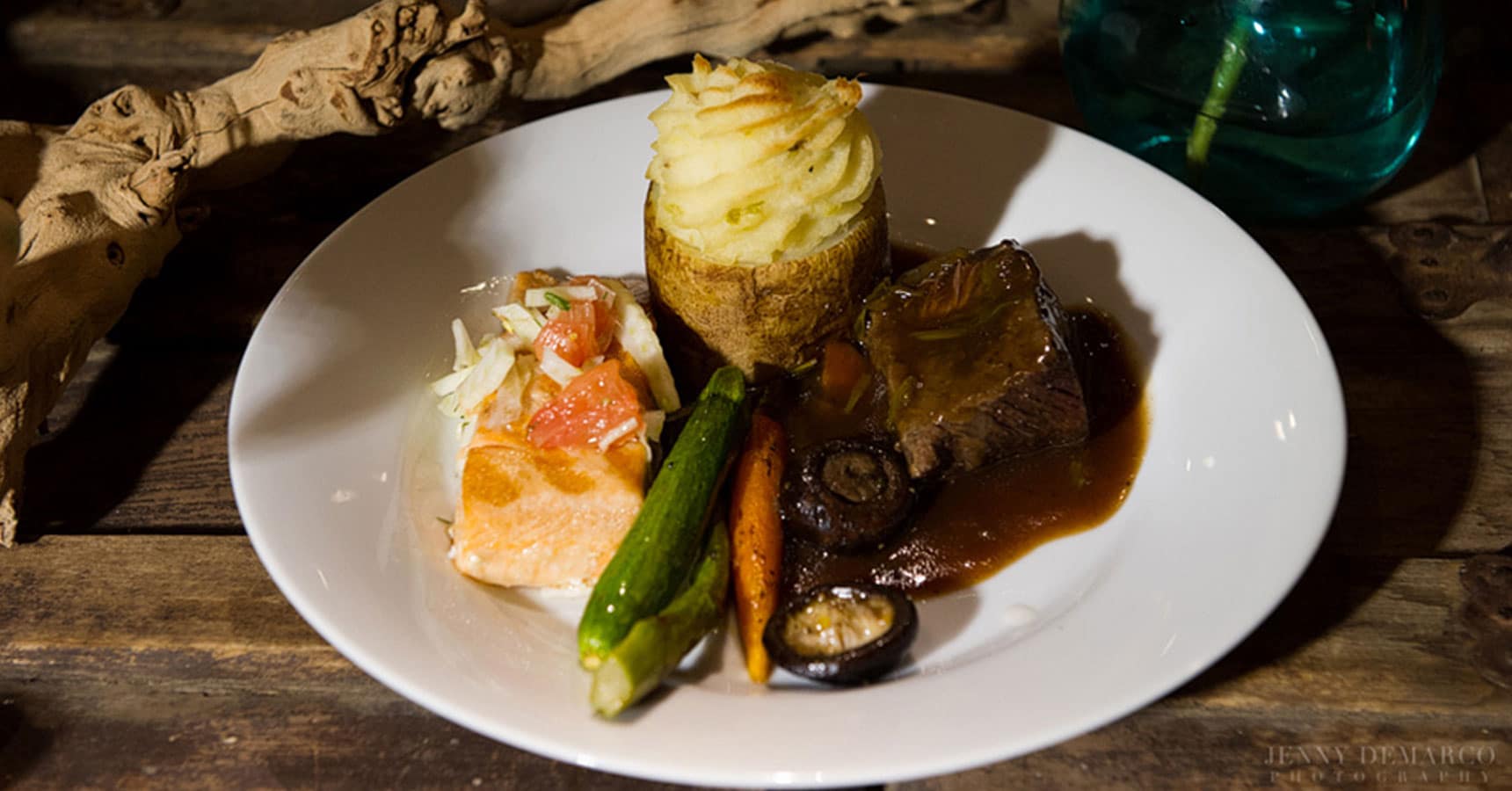 Braised beef short ribs with root vegetables, petite salmon filet plated entrees by crave catering