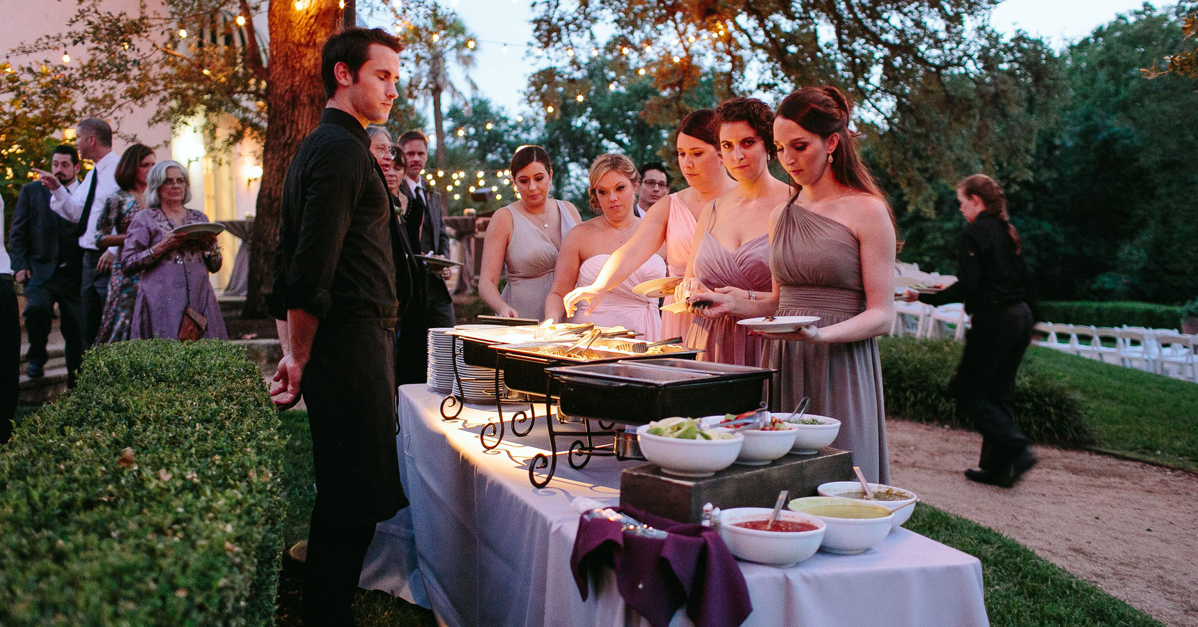 bridal party getting food from the buffet
