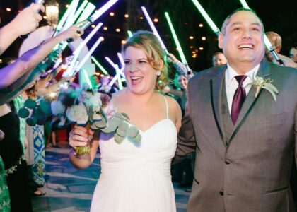 Bride and groom exiting under a lightsaber salute
